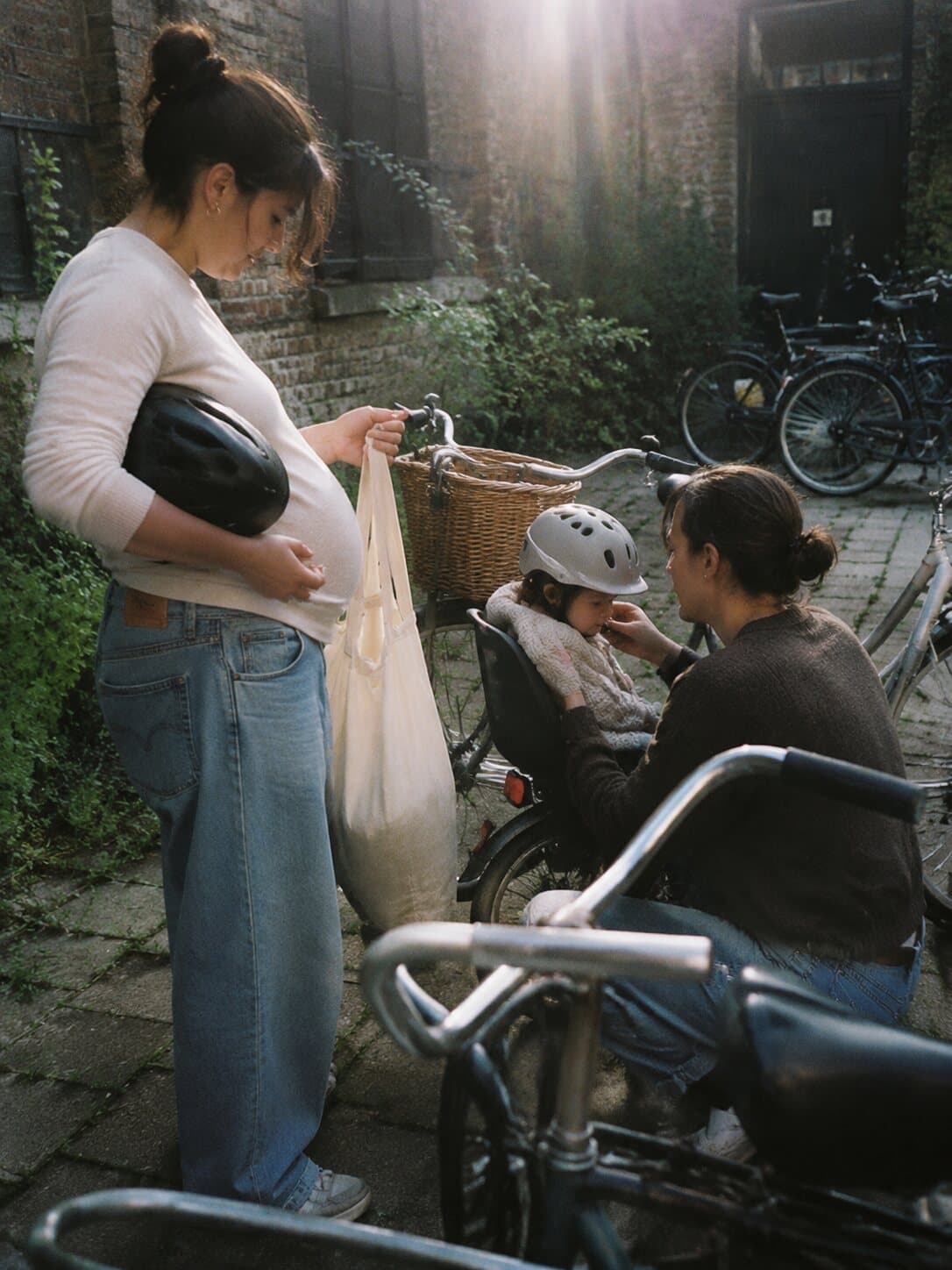 A family preparing their bicycles in a Copenhagen courtyard